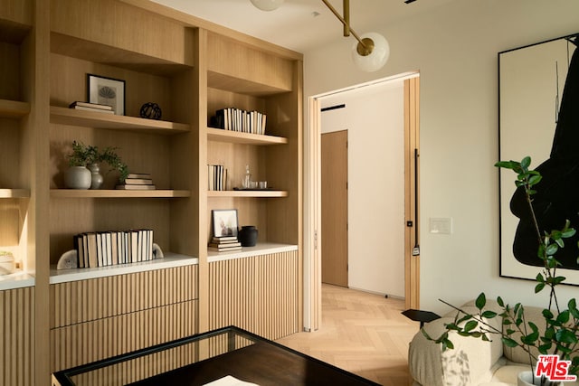 interior space featuring built in features and light parquet floors