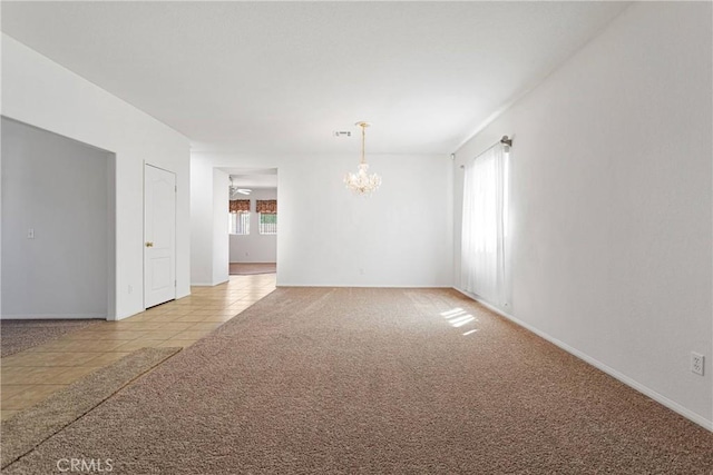 15121 Sorrel Rd, Victorville, CA 92394 - empty room with a chandelier, light tile patterned floors, light colored carpet, and baseboards