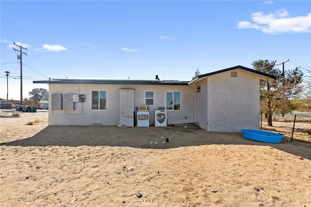 rear view of property featuring washer / clothes dryer