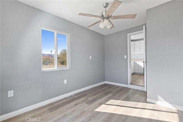 unfurnished bedroom with ceiling fan and light wood-type flooring