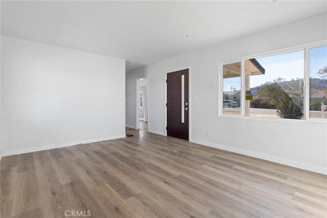 empty room with light hardwood / wood-style floors