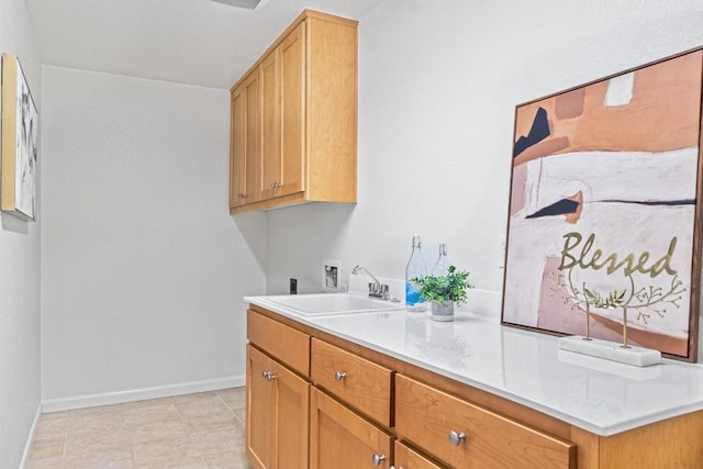 washroom featuring cabinets, hookup for a washing machine, and sink