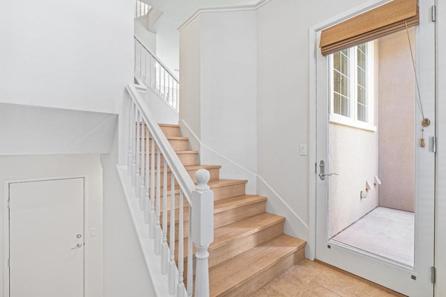 stairs featuring tile patterned flooring