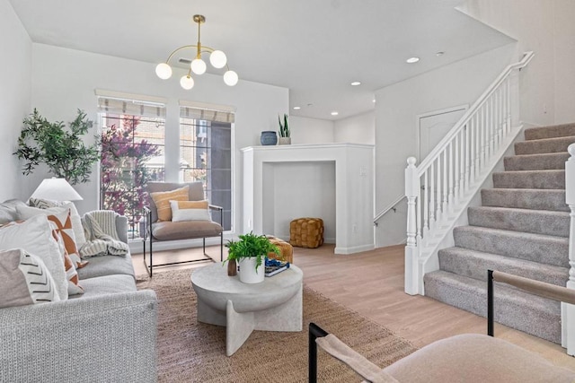 living room with an inviting chandelier and hardwood / wood-style floors