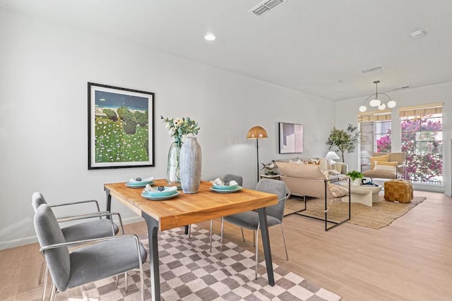 interior space featuring a chandelier and light hardwood / wood-style floors