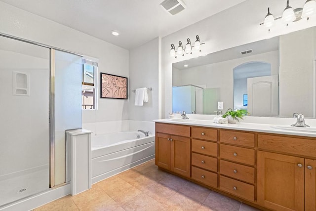 bathroom with vanity, tile patterned floors, and plus walk in shower