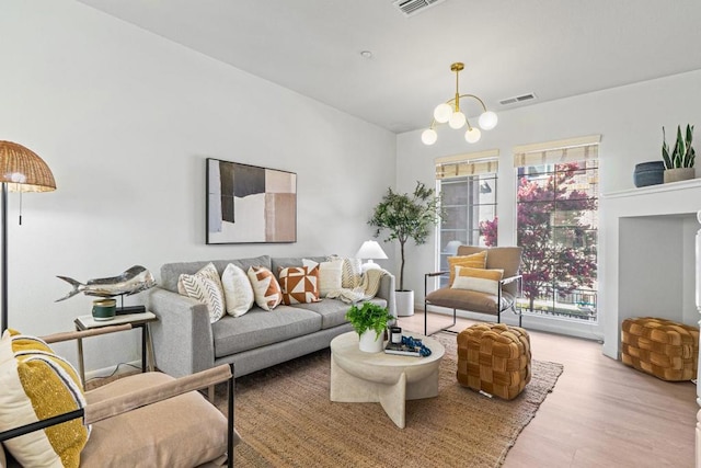 living room featuring a notable chandelier and light hardwood / wood-style flooring