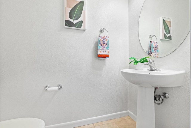 bathroom featuring toilet and tile patterned floors