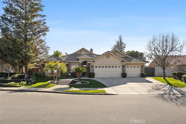 view of front of property featuring a front yard and a garage