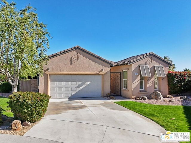 ranch-style home featuring a front lawn and a garage