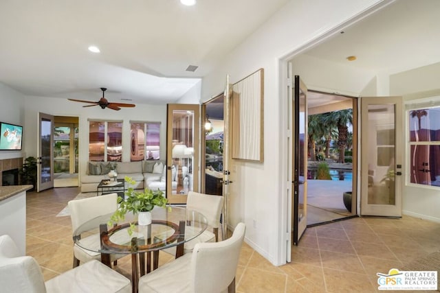 dining space with ceiling fan, french doors, and light tile patterned floors