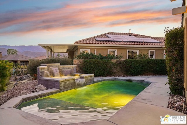 pool at dusk with a mountain view