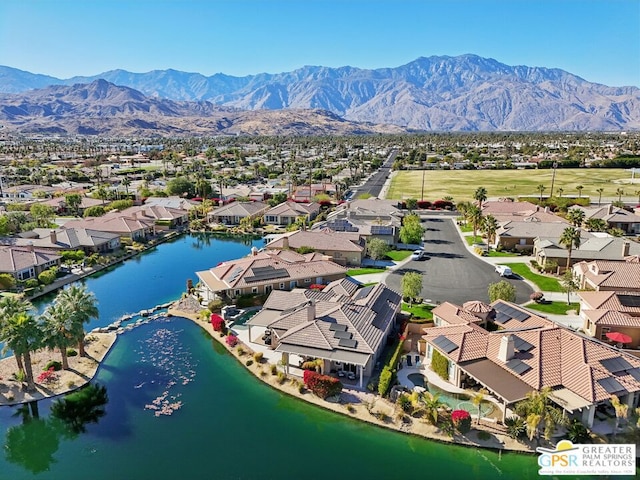 birds eye view of property featuring a water and mountain view