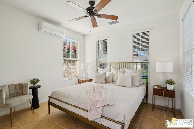 bedroom featuring ceiling fan, a wall mounted air conditioner, and tile patterned floors