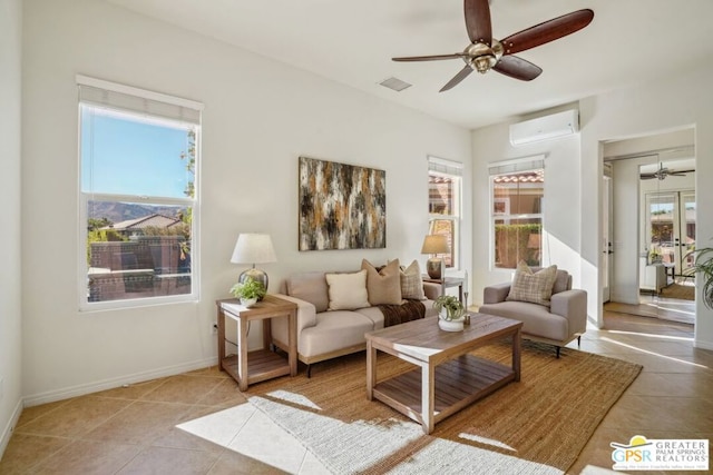 living room with a wall unit AC, ceiling fan, and light tile patterned floors