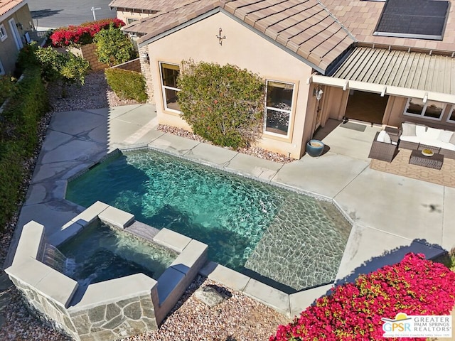 view of swimming pool with an outdoor hangout area, an in ground hot tub, and a patio area