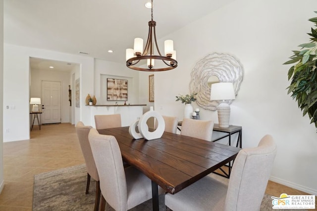 tiled dining area featuring a chandelier