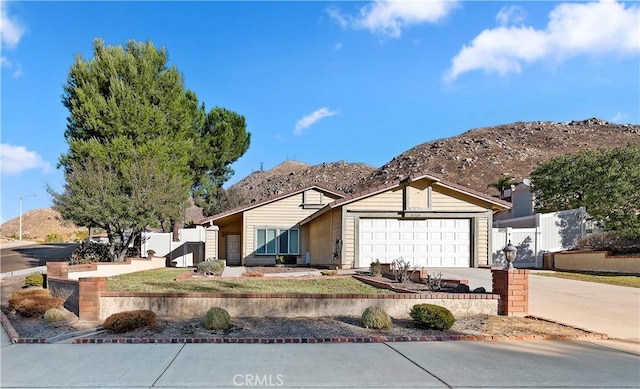 ranch-style home with a mountain view and a garage