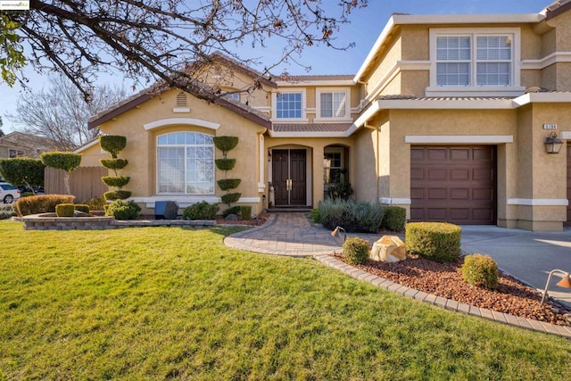 view of front facade featuring a garage and a front lawn