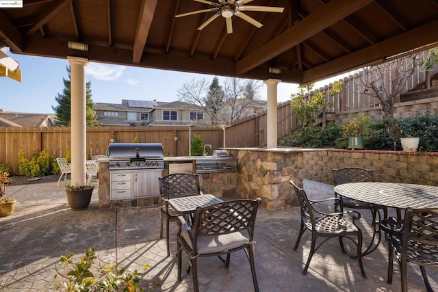 view of patio / terrace with an outdoor kitchen, a gazebo, ceiling fan, and a grill