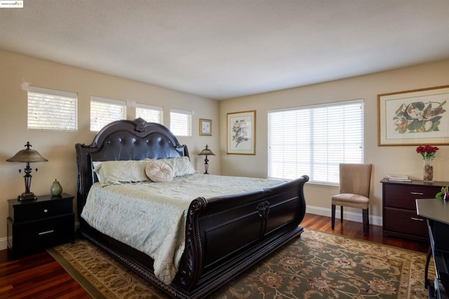 bedroom with dark hardwood / wood-style flooring