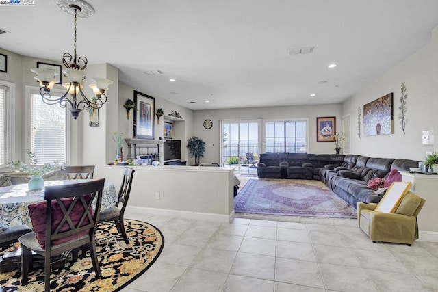 dining space with a notable chandelier and light tile patterned floors