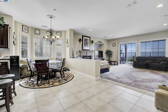 dining room featuring a notable chandelier and light tile patterned floors