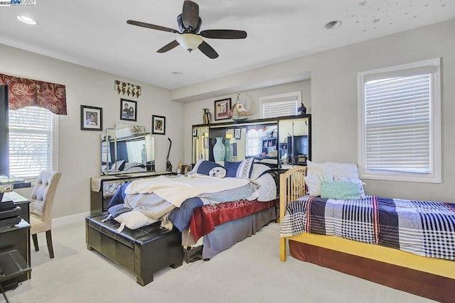 bedroom with ceiling fan and light carpet