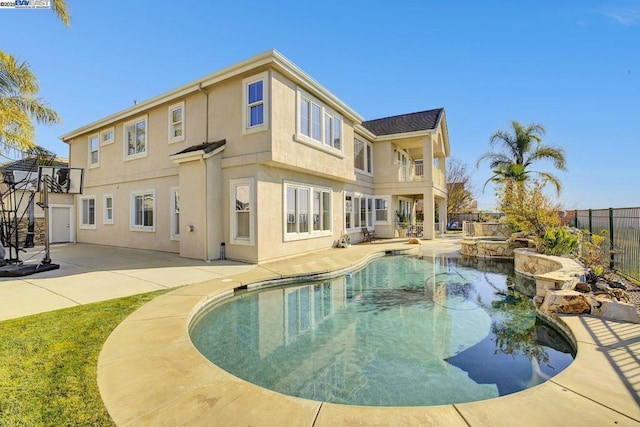 back of property with a balcony, a fenced in pool, and a patio area