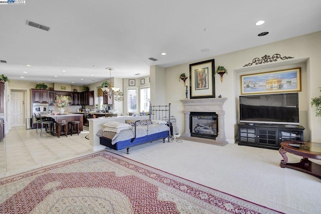 carpeted living room featuring an inviting chandelier