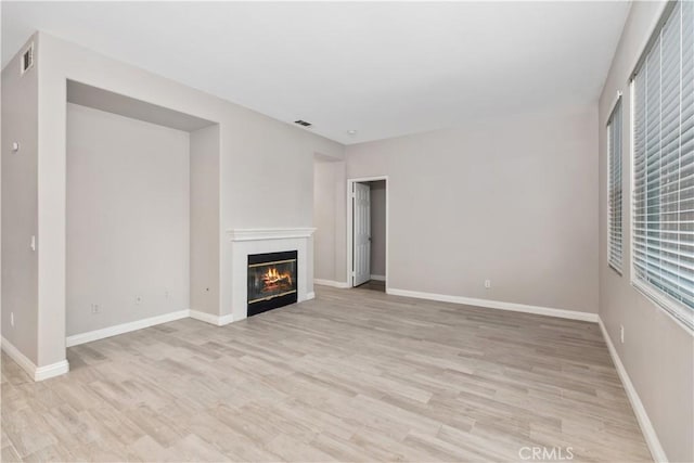 unfurnished living room with light hardwood / wood-style flooring