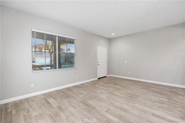 spare room featuring light hardwood / wood-style floors