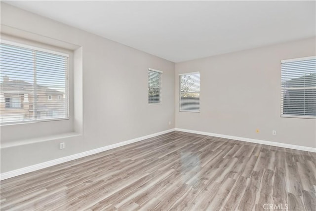 spare room featuring light hardwood / wood-style floors