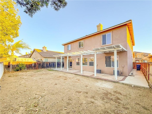 back of house featuring central air condition unit, a patio area, and a pergola