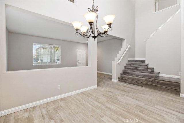 interior space featuring an inviting chandelier and light wood-type flooring