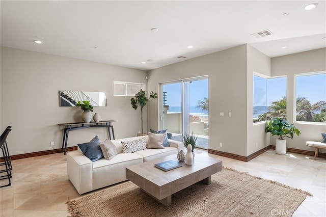 living room with visible vents, a healthy amount of sunlight, and baseboards