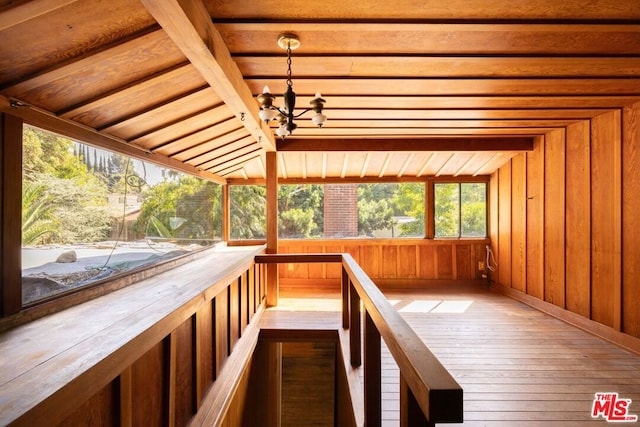 unfurnished sunroom with an inviting chandelier