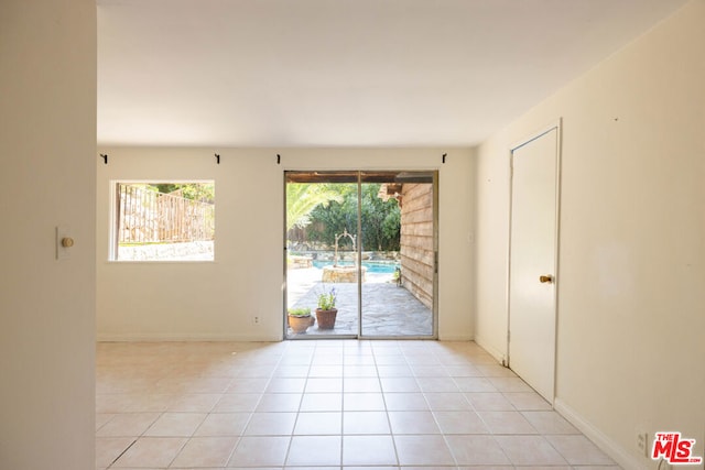 spare room featuring light tile patterned floors