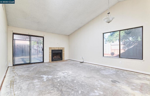 unfurnished living room with a textured ceiling, a tile fireplace, and high vaulted ceiling