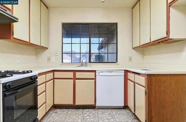 kitchen with white dishwasher, gas range, and cream cabinetry