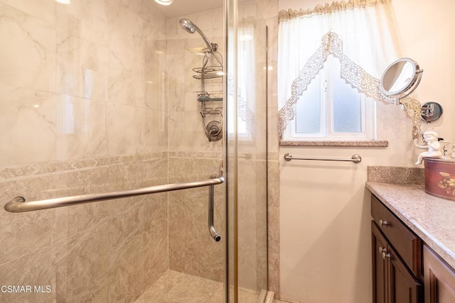 bathroom with vanity and a shower with shower door