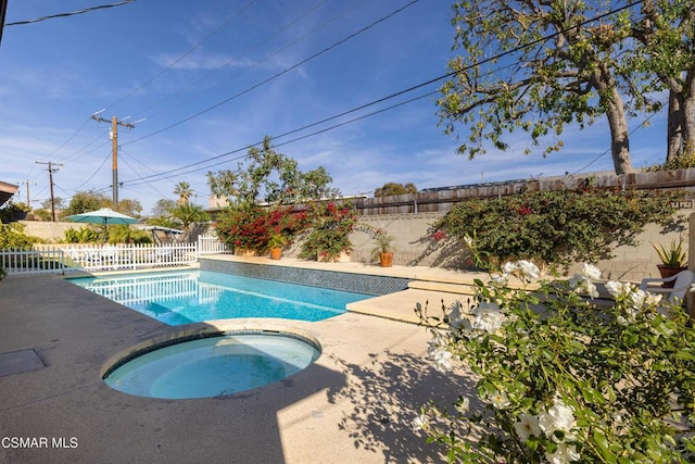 view of pool with an in ground hot tub