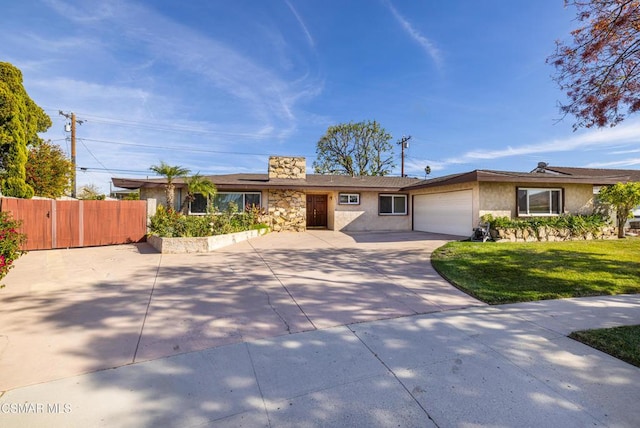 ranch-style home with a garage and a front lawn