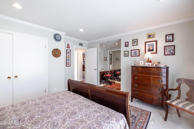 bedroom with carpet floors, a closet, and ornamental molding