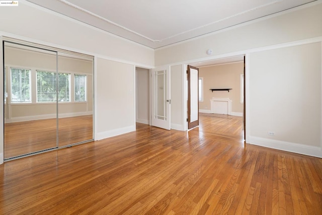 empty room with hardwood / wood-style flooring