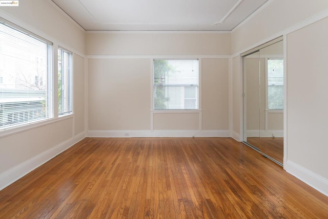 empty room featuring crown molding and hardwood / wood-style floors