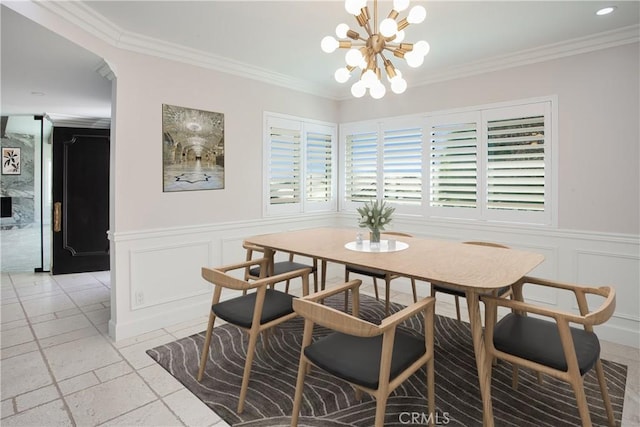 dining space featuring ornamental molding and a chandelier