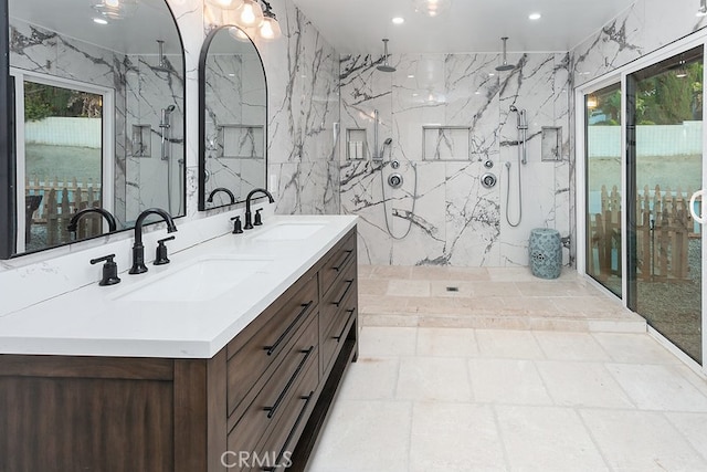 bathroom with plenty of natural light, tile walls, walk in shower, and vanity