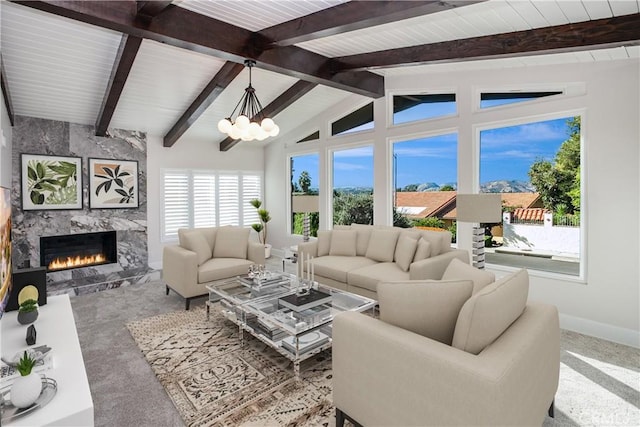 carpeted living room with vaulted ceiling with beams, a chandelier, and a fireplace