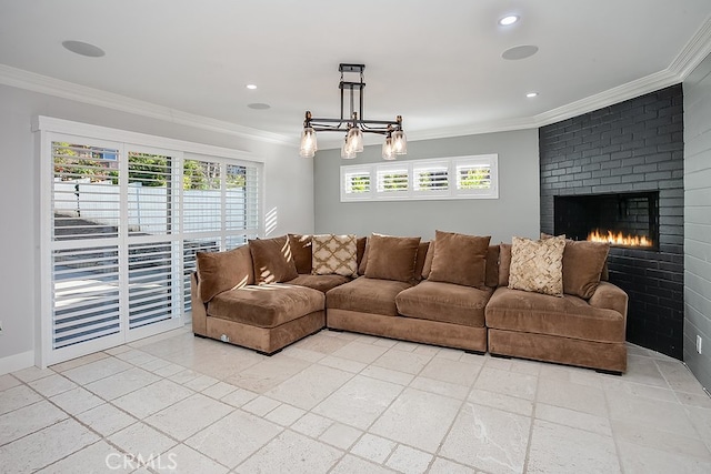 living room with crown molding, a chandelier, and a fireplace